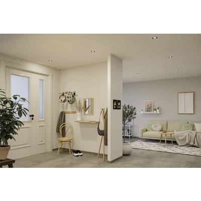 Living room with light wall colour. A sofa, a small table, plants and decorations create an inviting atmosphere.
