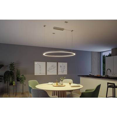 A modern dining room with a round, suspended LED light fitting over a wooden table, surrounded by chairs. Minimalist artworks adorn the wall.