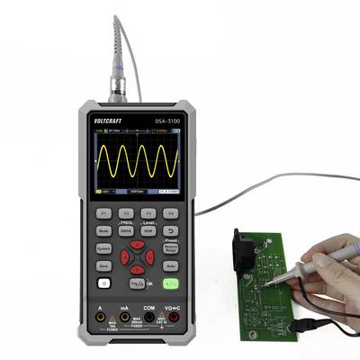 Hand holding a probe testing a circuit board with an oscilloscope, displaying a yellow waveform on the screen, labeled 'VOLTCARFT DSA-3100'.