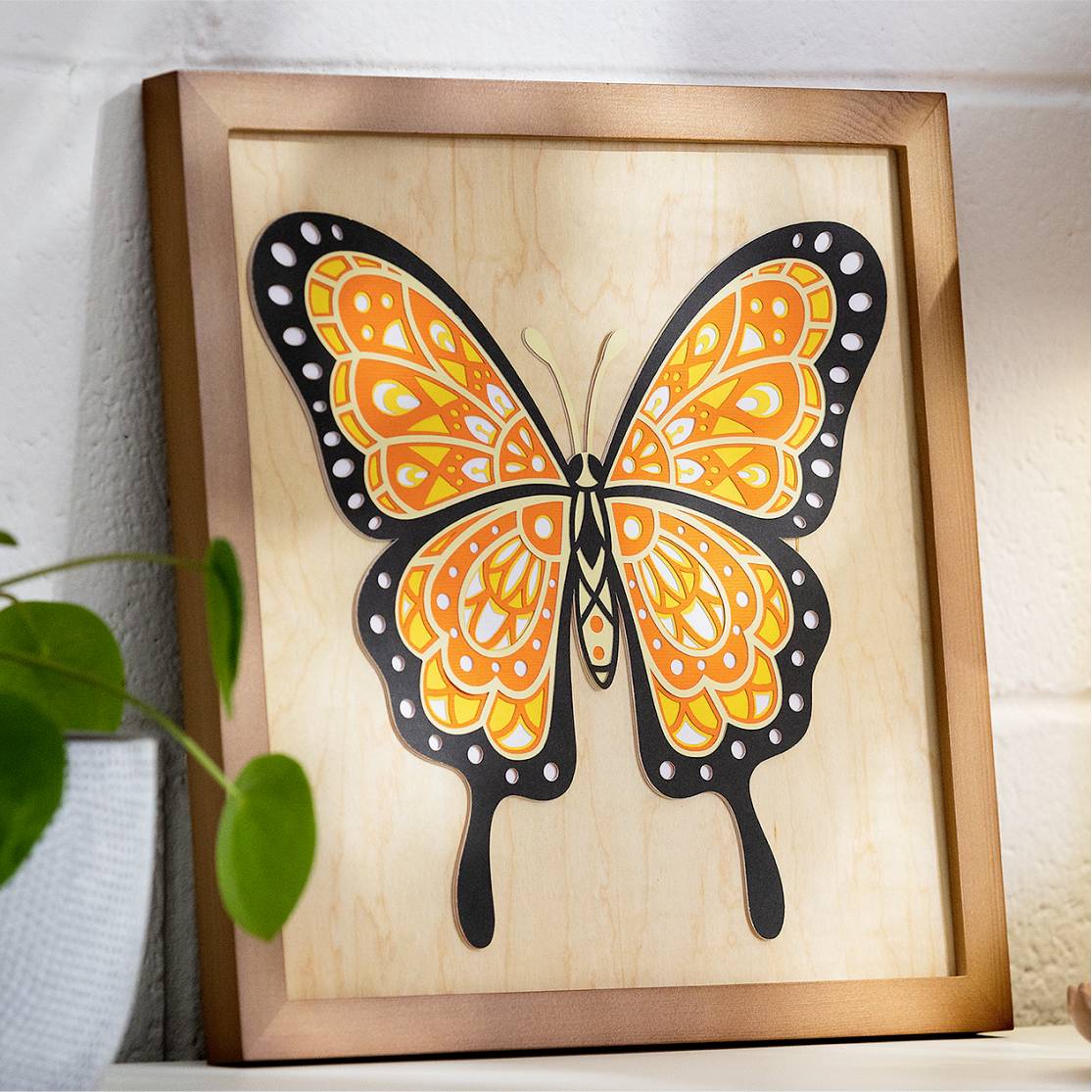 A framed artwork on a wall depicts a stylised, colourful butterfly with orange and black wings.