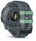 Back of a robust, grey digital wristwatch with a green accent on the strap, optical sensors and 'INSTINCT' marking.