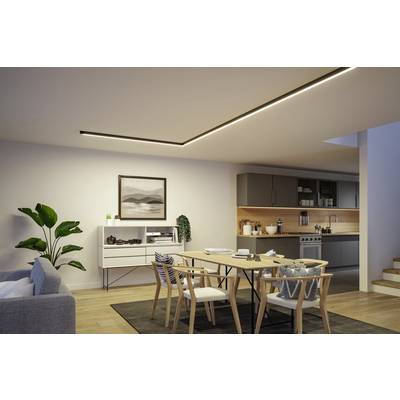 Modern living room with dining area. Wooden table with chairs, grey sofa on the left, white sideboard and plant on the right. Integrated kitchen in the background.