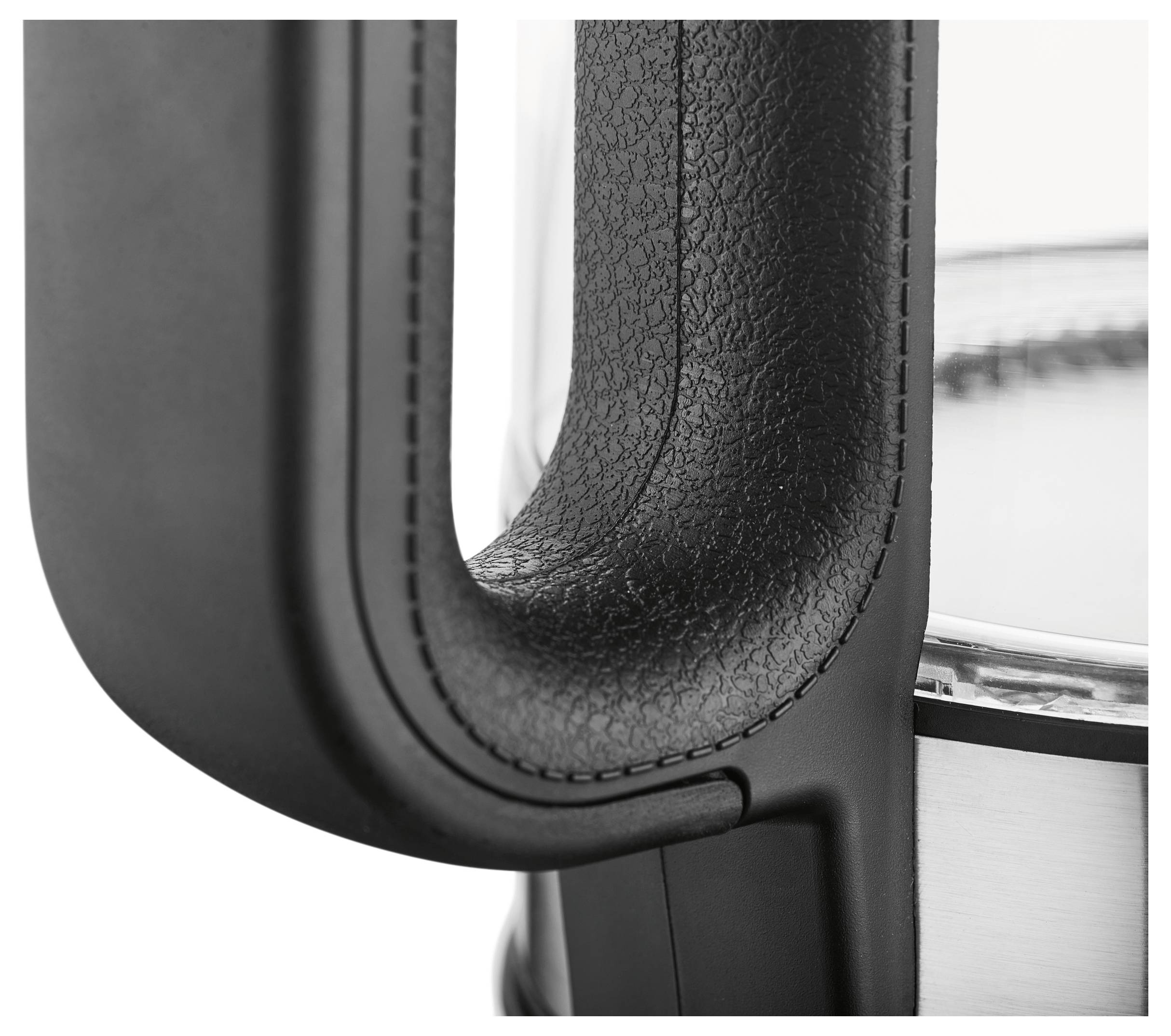 Close-up of a black, textured handle on a stainless steel appliance, likely part of a kettle.