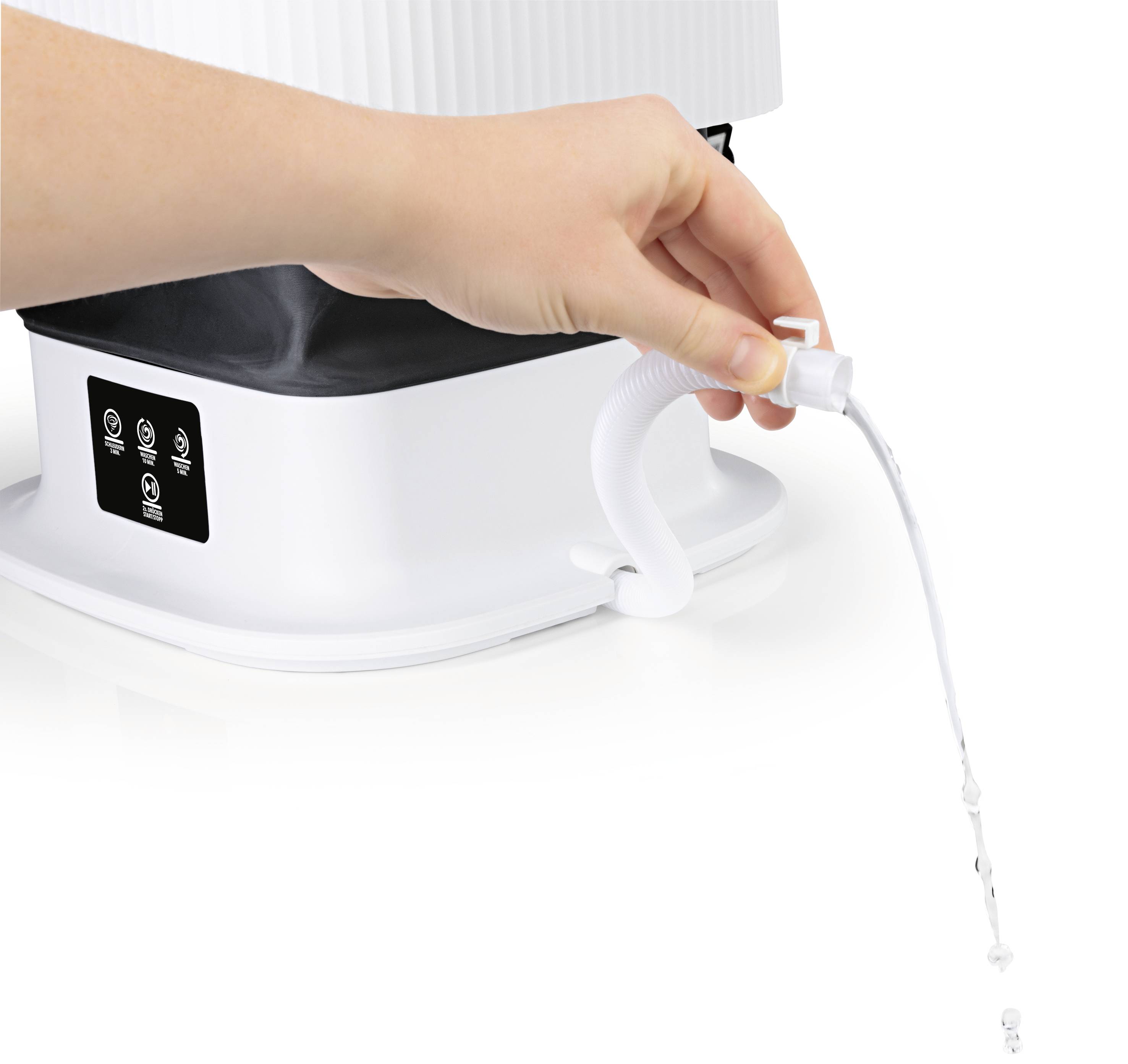 A hand operates a flexible water outlet of a white device, from which a thin stream of water is flowing.