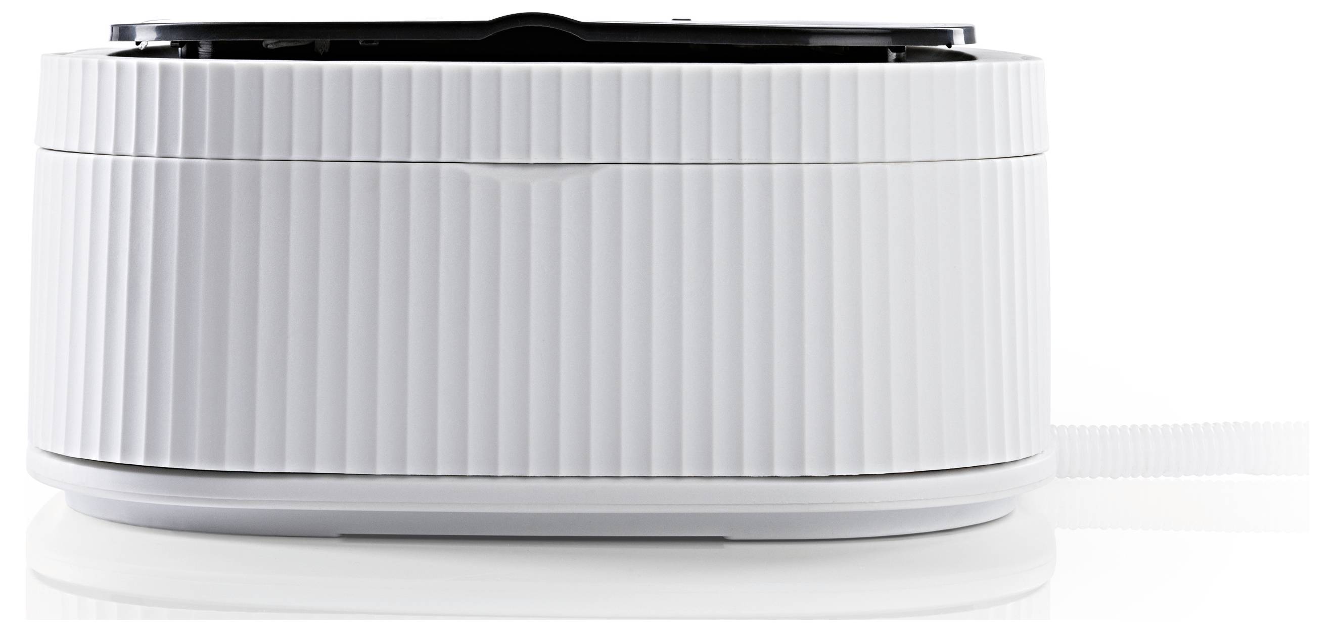 White, cylindrical device with a ribbed surface resting on a smooth, glossy surface.