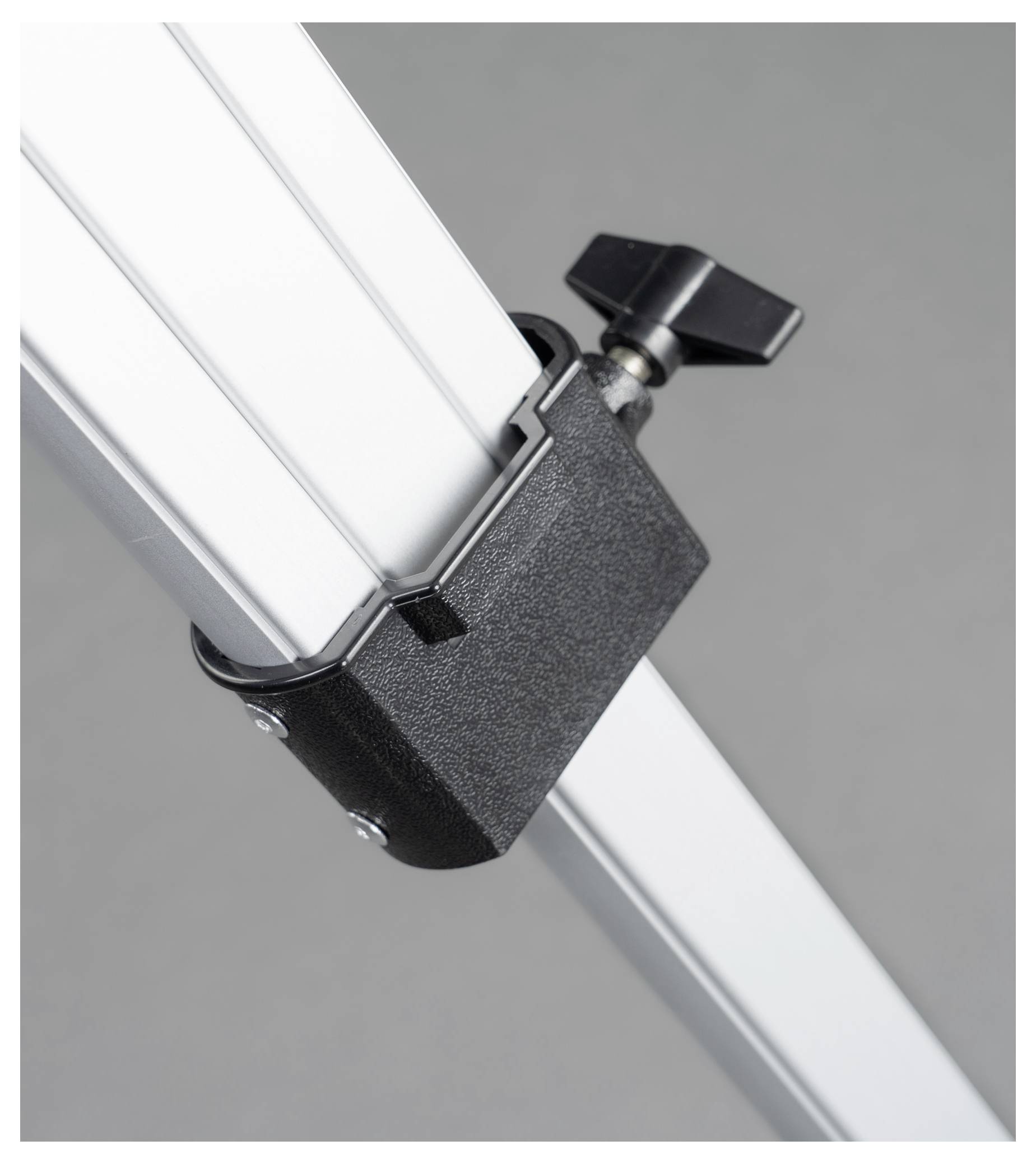 Clamping mechanism with black rotary knob on metal rail.