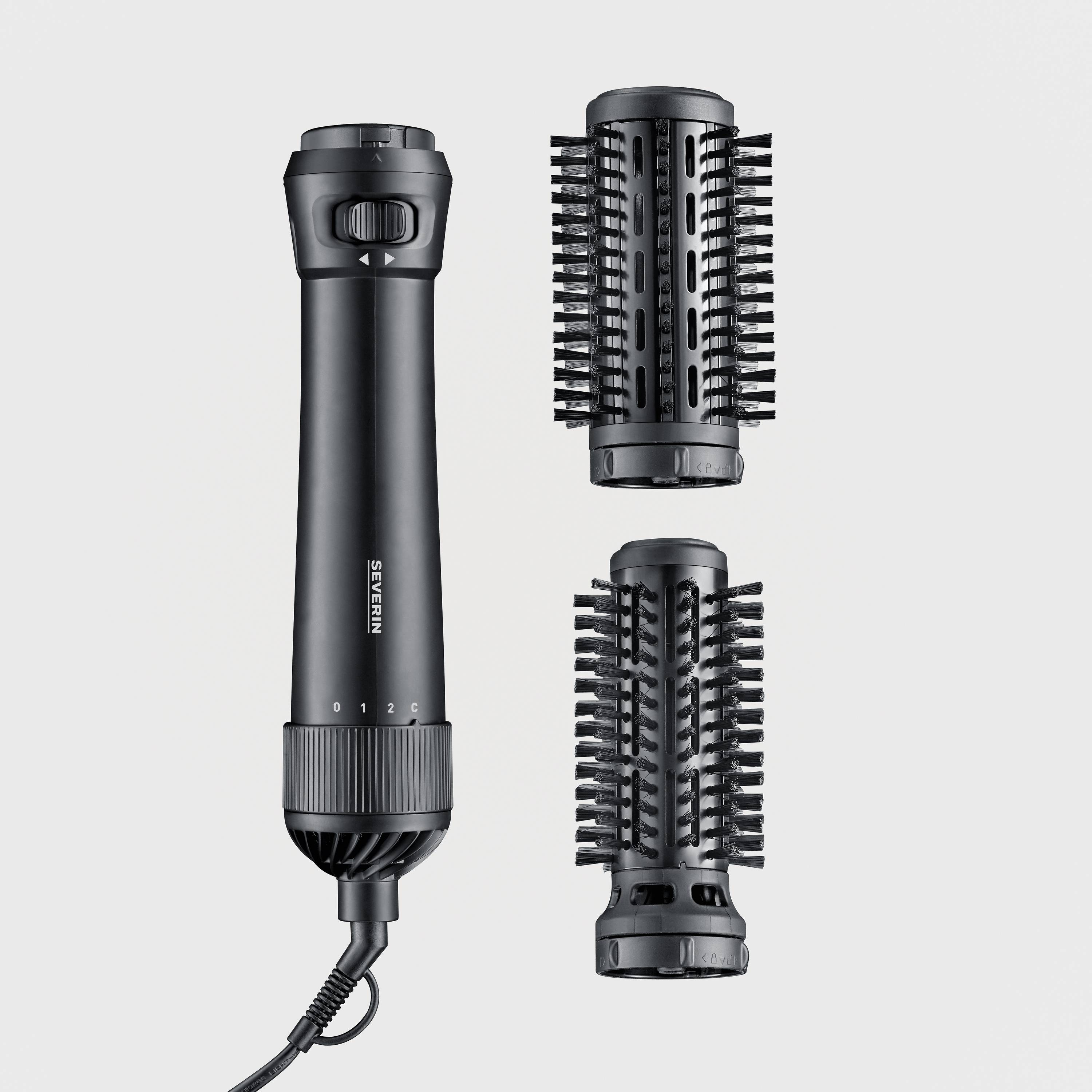 Black hot air brush with two interchangeable brush attachments; used for styling and drying hair.