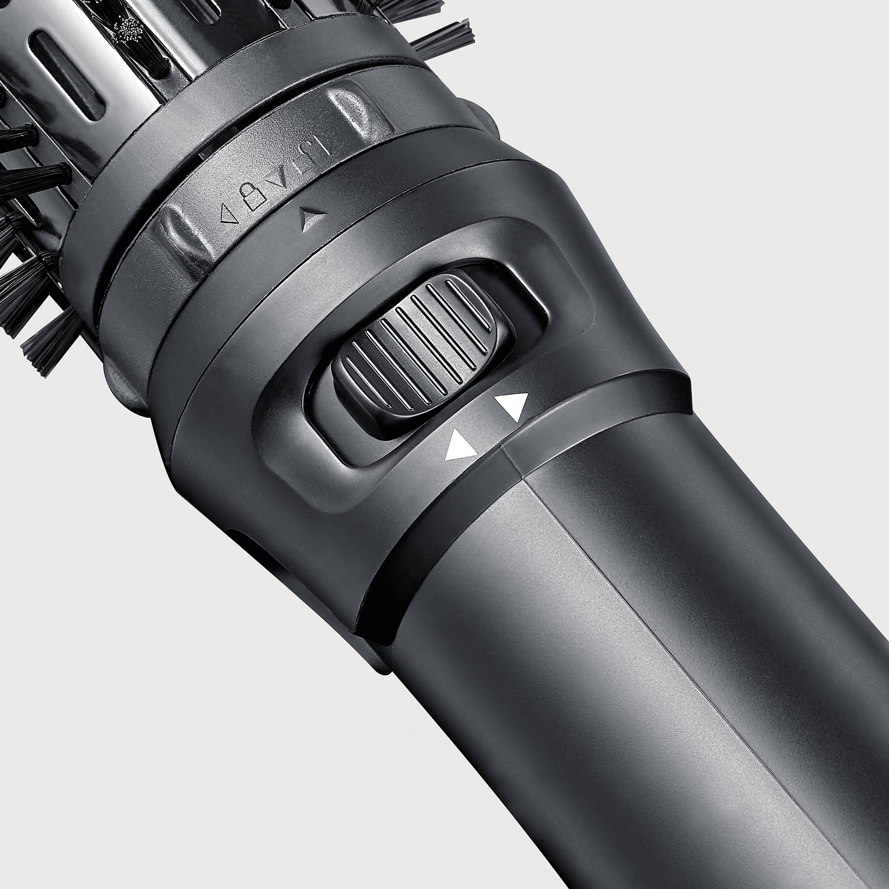 Close-up of a black electronic device with a small wheel and arrow indicator. Could be part of a tool or household appliance.