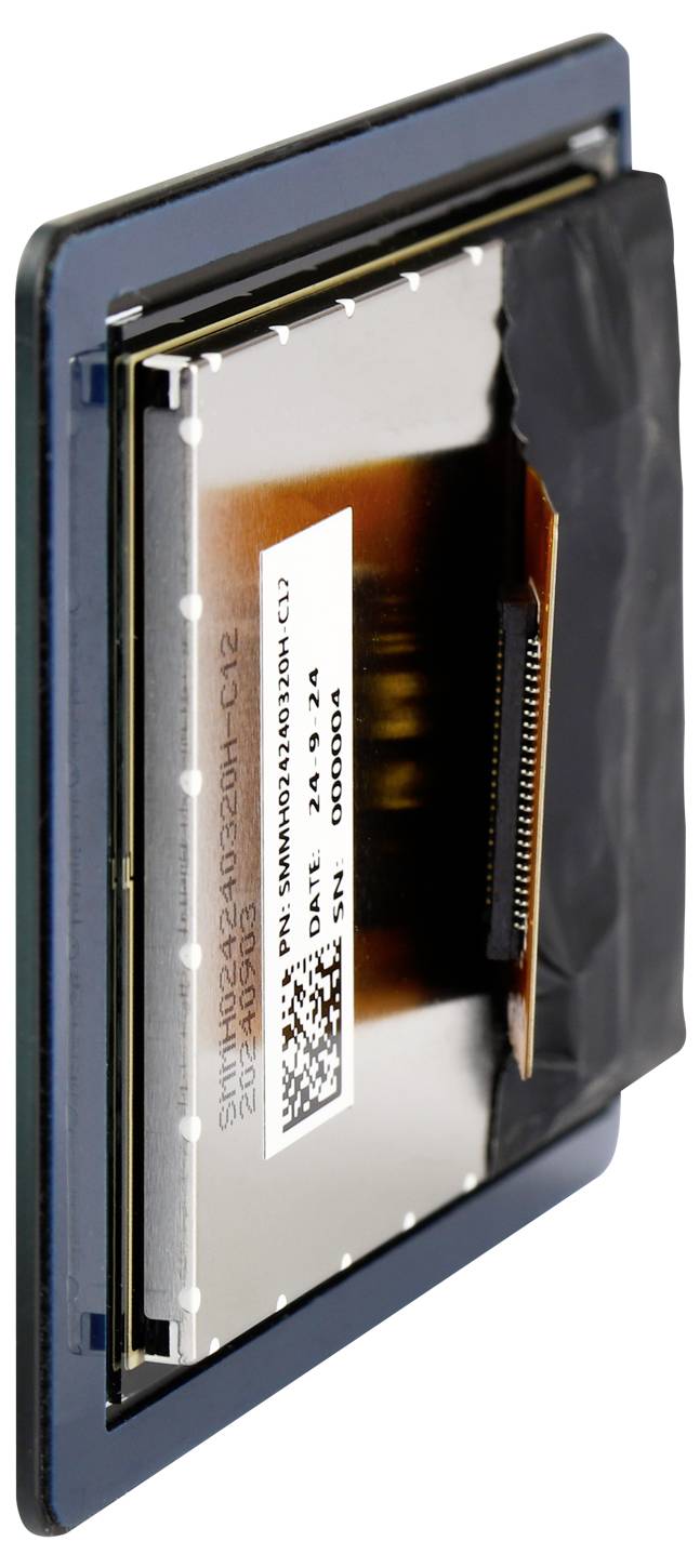 Close-up of a computer processor with visible circuit boards and data chips. The processor is mounted in a protective casing.