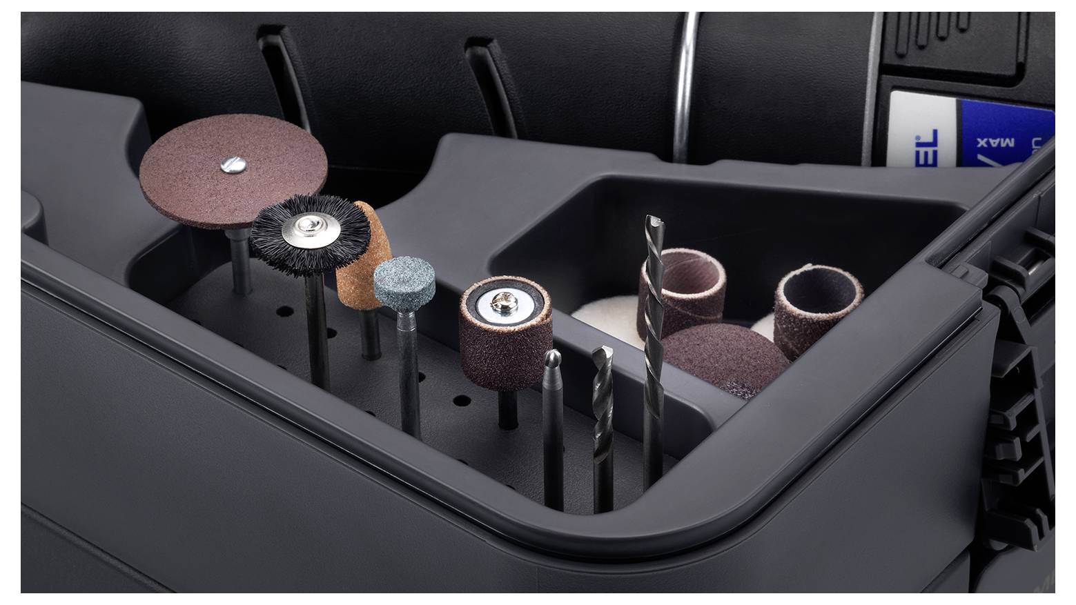 A black tool case displays various grinding and drilling tools arranged in compartments, ready for use.