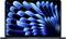 A laptop with a screen displaying a dynamic, abstract graphic pattern in blue tones.