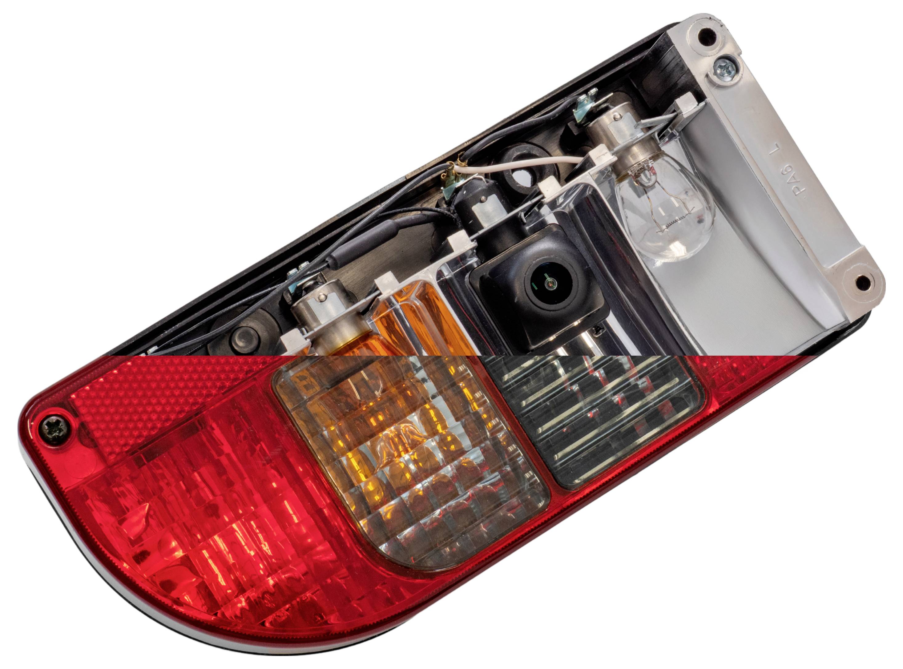 Close-up of a car taillight assembly showing internal components including bulbs and wiring, set against a plain white background.