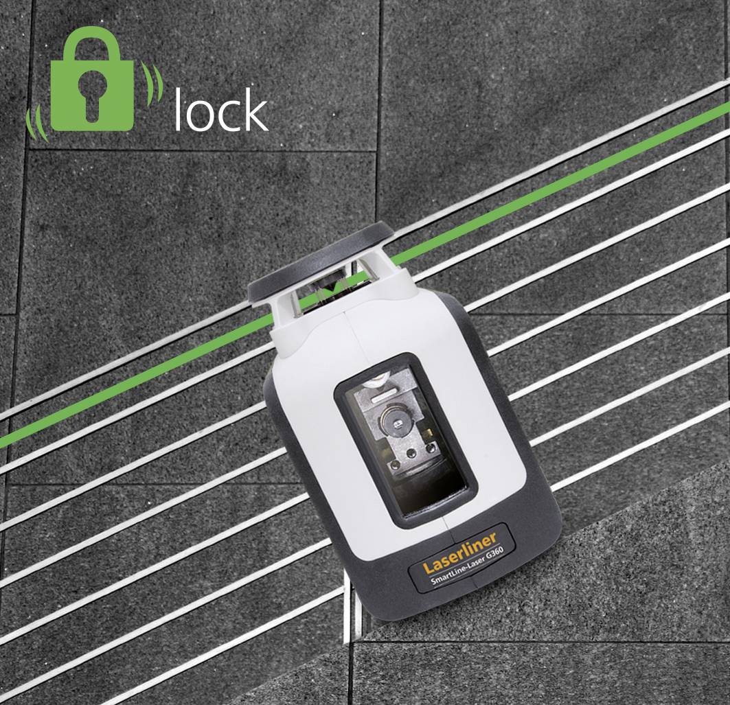 A laser levelling device projects green lines onto a dark floor covering. A "lock" symbol in the corner indicates a locking function.