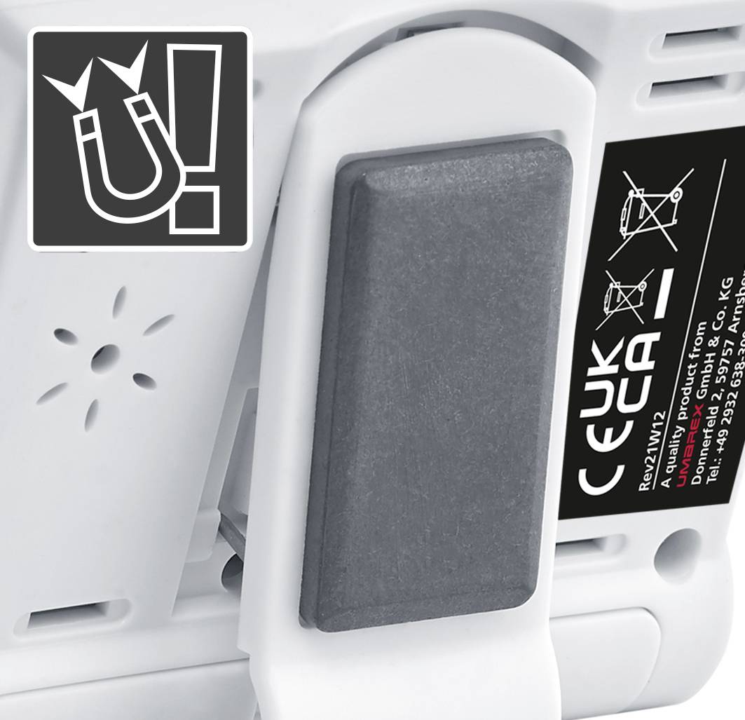 Magnetic warning sign on a device, next to safety stickers and a large black rectangular surface.