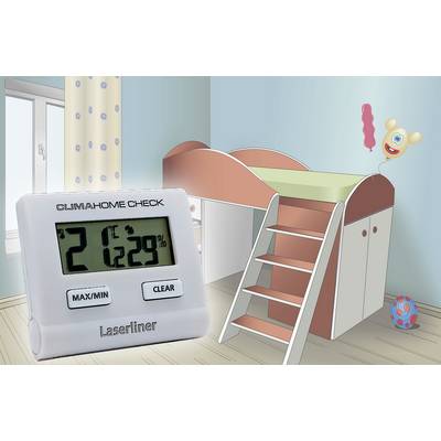 A digital thermo-hygrometer shows 21°C and 29% humidity. In the background, a children's bedroom with a high sleeper bed is visible.