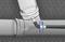 The graphic depicts a piping system with a flexible hose being inserted into a pipe. The hose is curved and indicates the direction of movement.