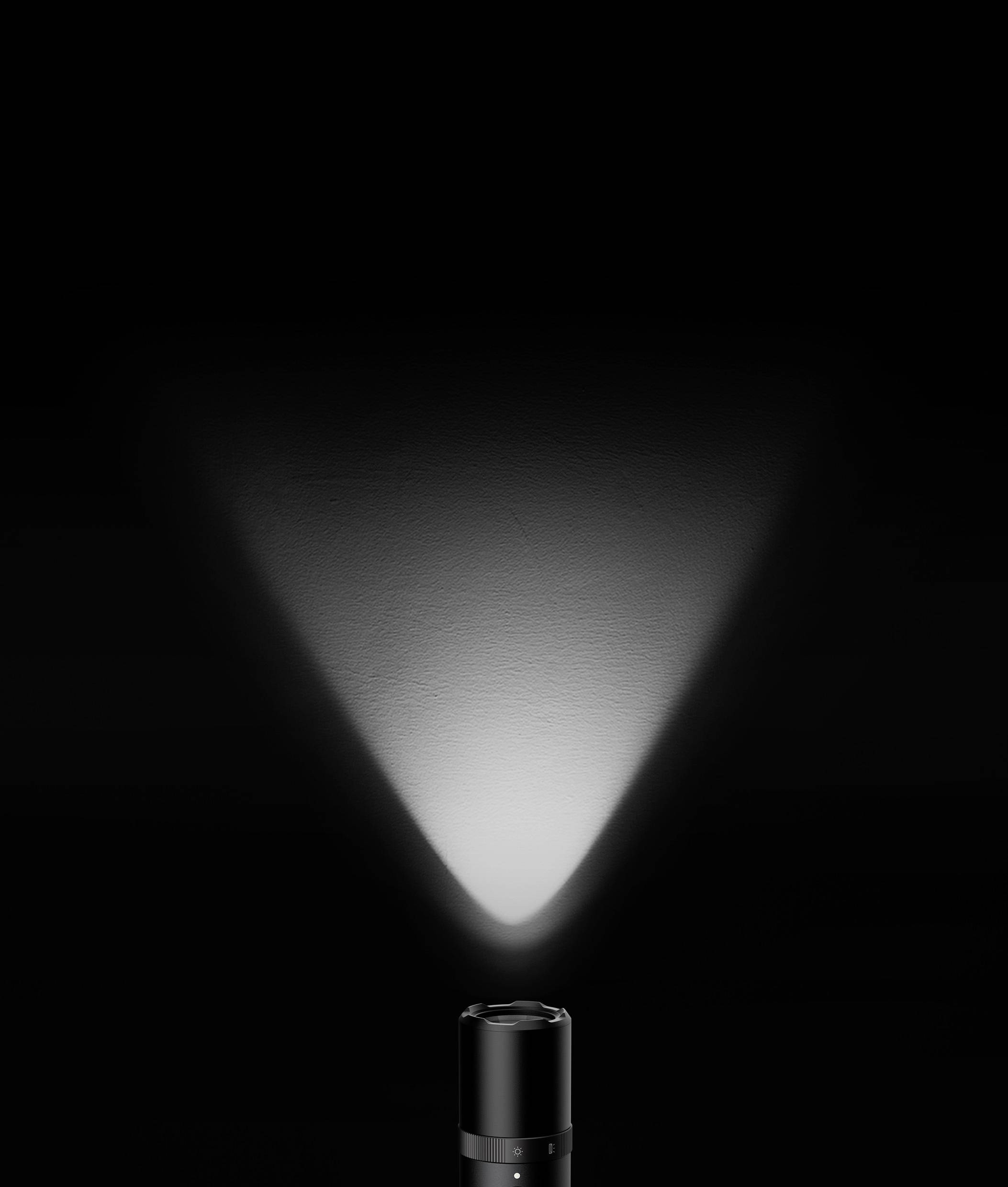 A black torch illuminates a dark room, its beam of light spreading upwards and to the side, casting light on the wall.