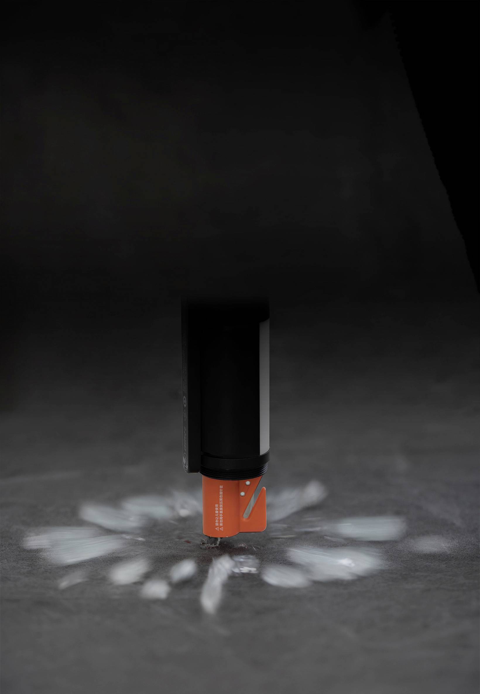 A device is spraying a powdery material onto a grey surface, creating a star-shaped pattern of fine particles.