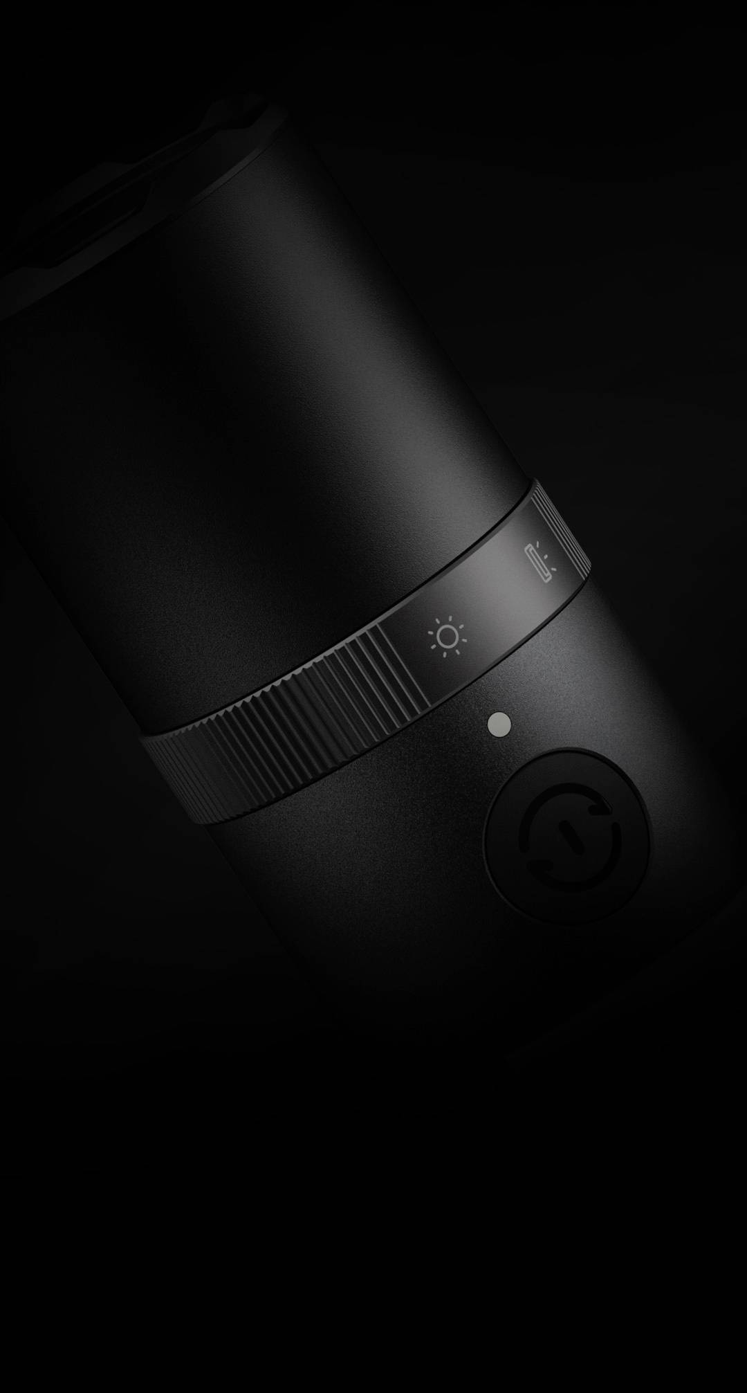 Black, cylindrical container with small wheels for brightness adjustment, set against a dark background. Likely suitable as a standing lamp.