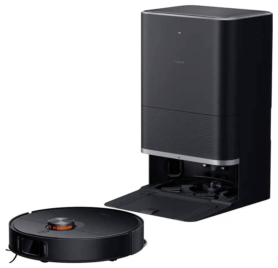 A round, black robotic vacuum cleaner in front of a black charging station that serves as a dust collection container. Efficient cleaning system.