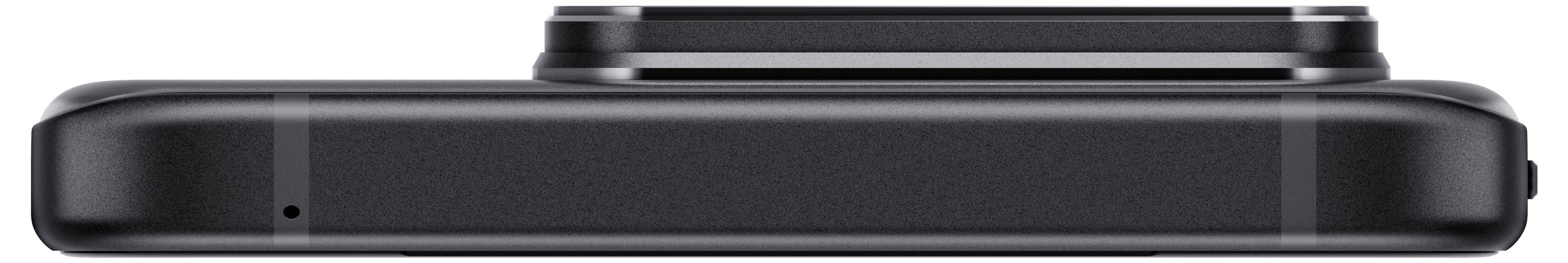 A black, flat electronic camera with minimalist design, lying on a white background, viewed from the side.