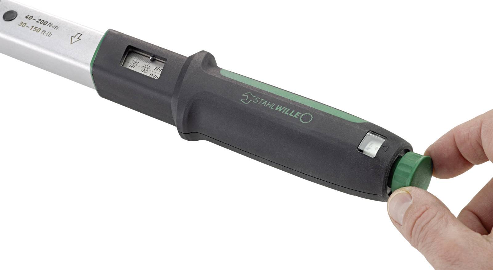 A torque wrench with a digital display is being adjusted. A hand is turning the green adjustment knob on the handle of the tool.