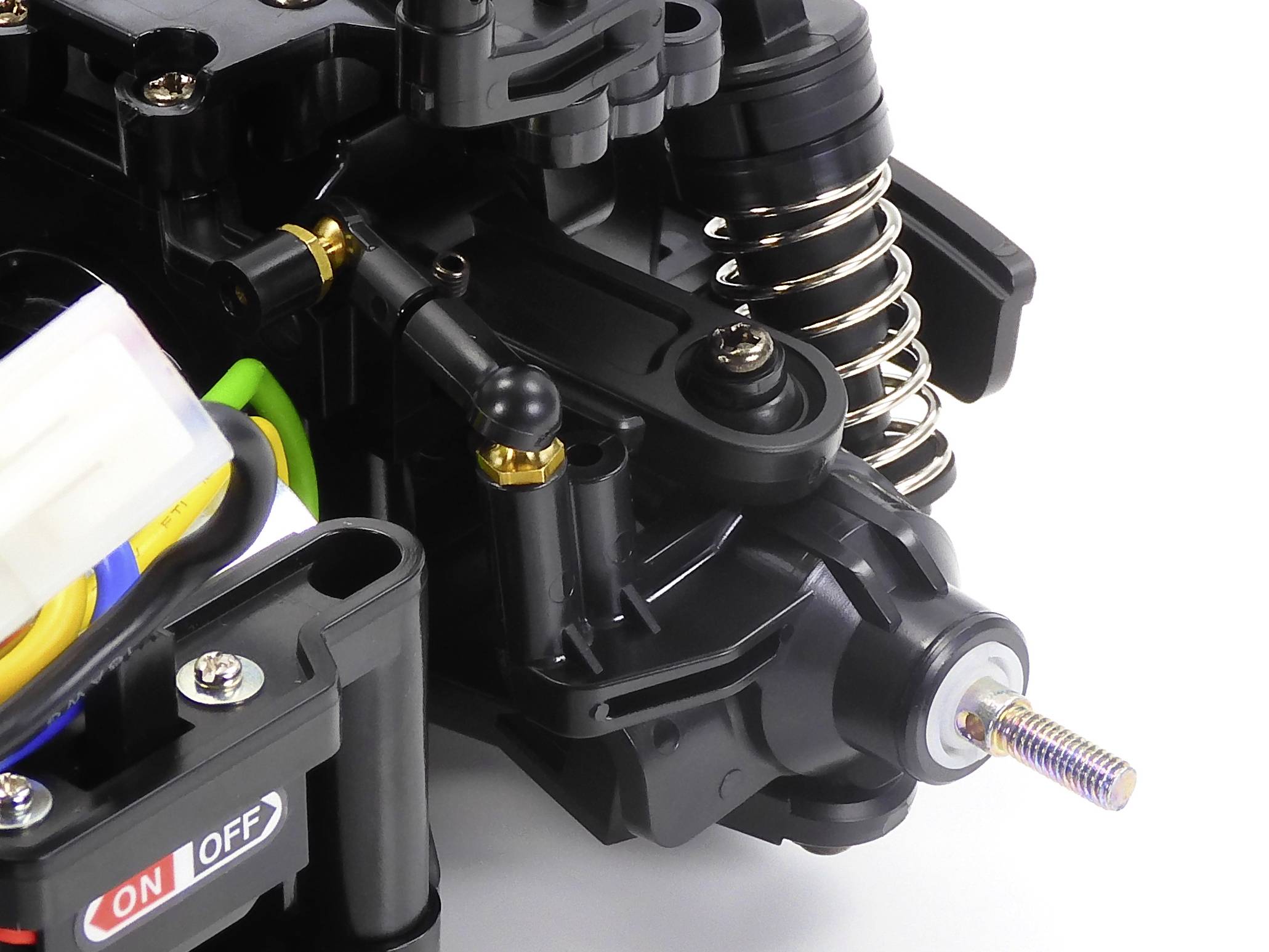 Close-up of a complex mechanical component with springs and switches. An 'ON/OFF' switch and a spiral spring are visible.