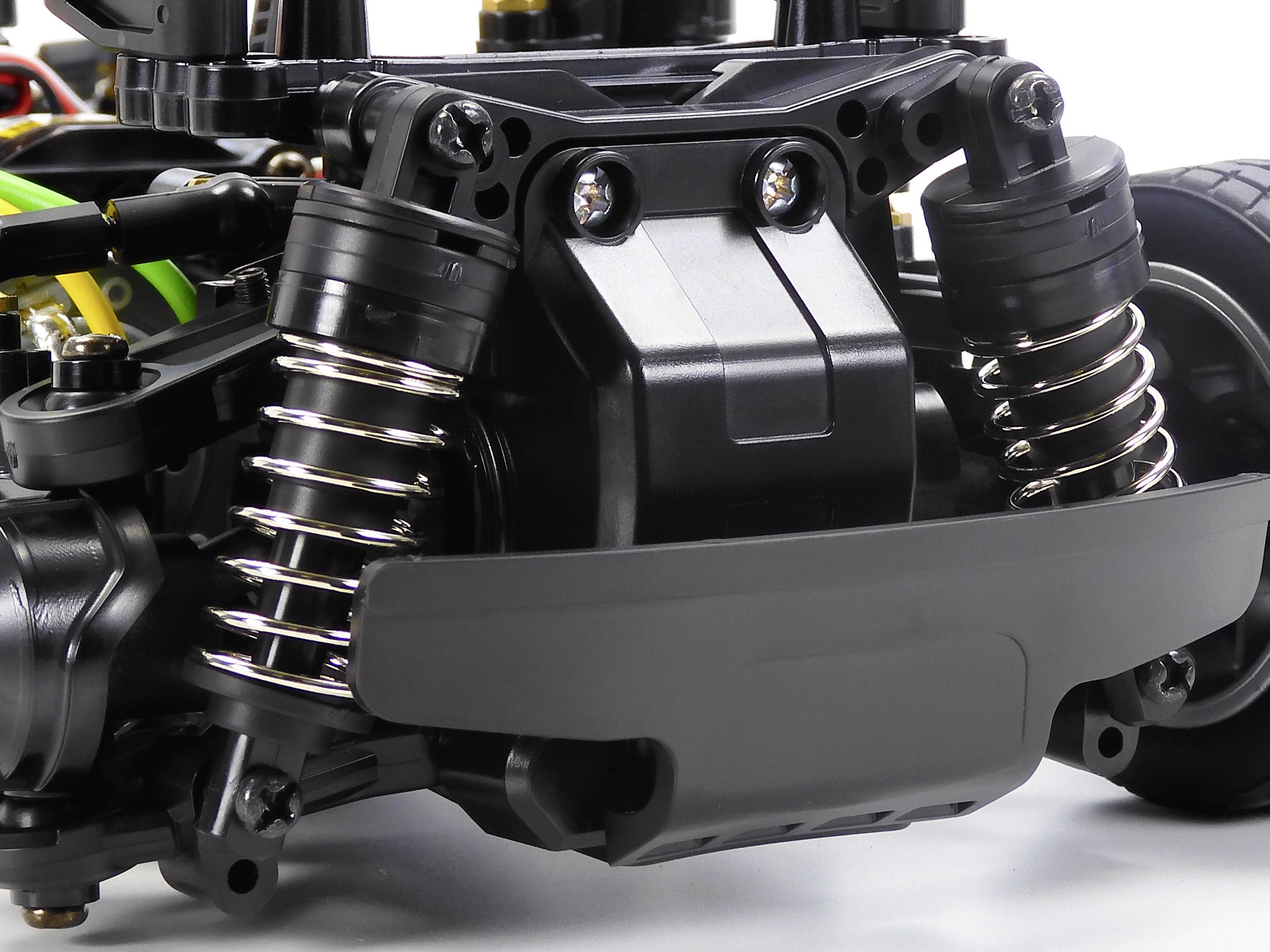 Close-up of a remote-controlled car with visible shock absorbers and suspension components.