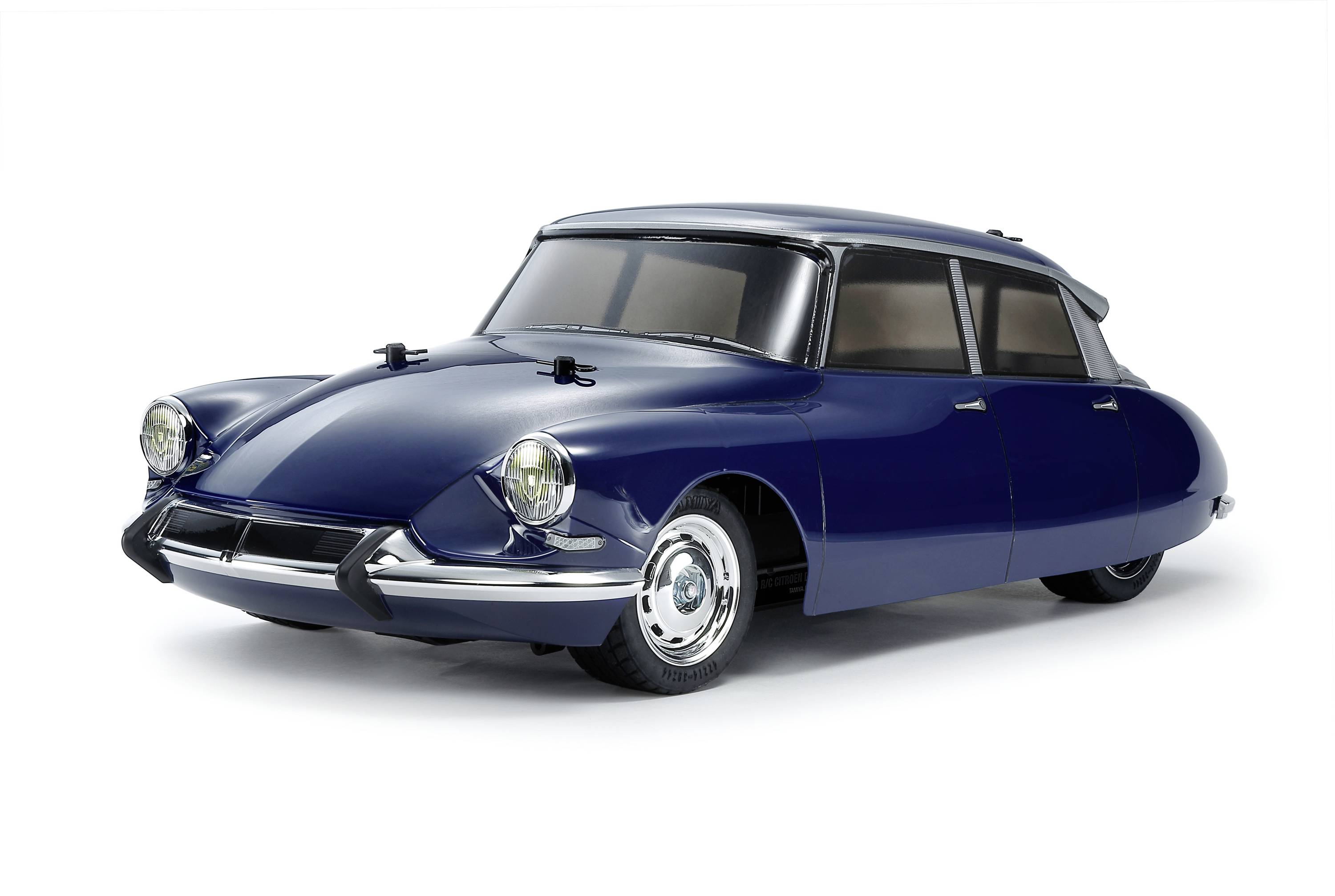 Classic dark blue car with a unique streamlined design, highlighted by round headlamps and a smooth bodywork.