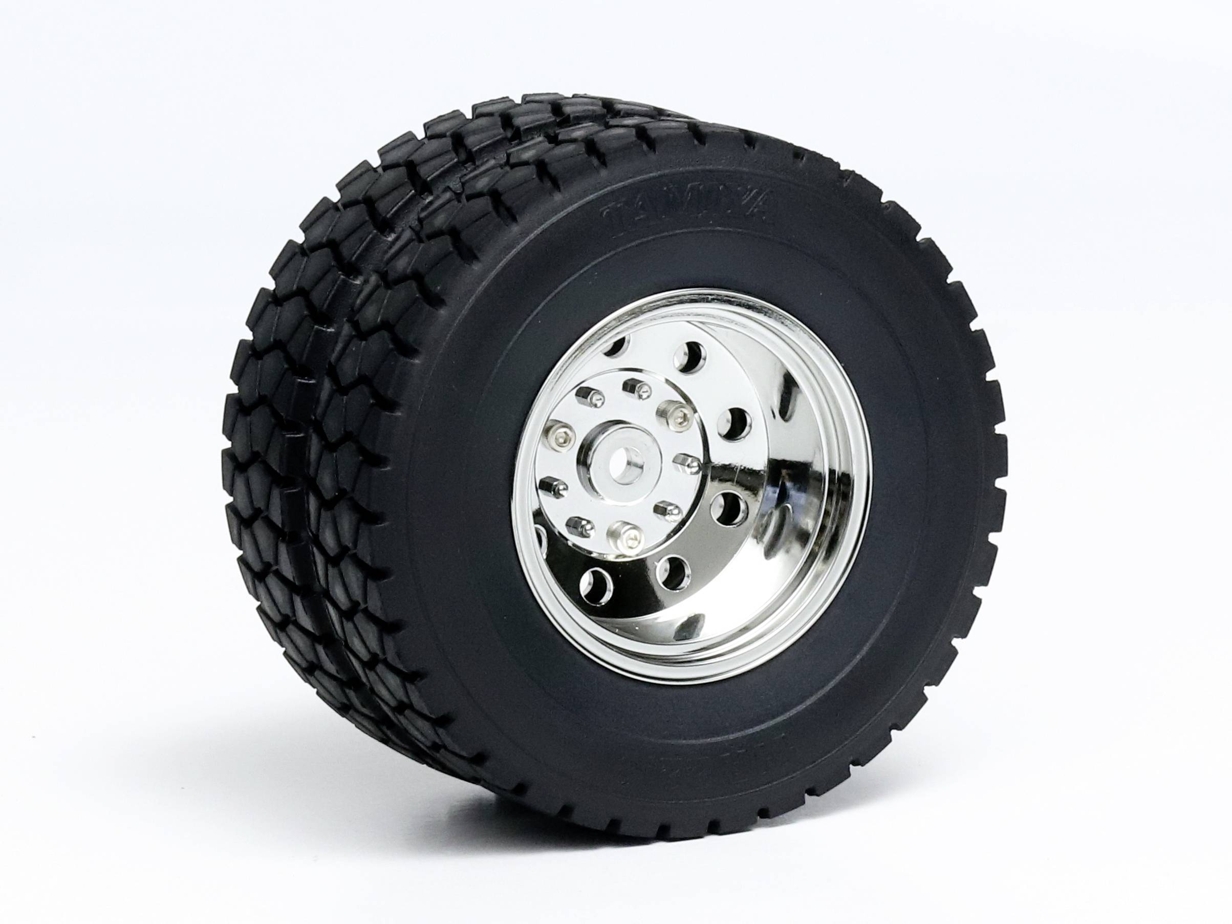 A single large, black tyre with a silver, shiny wheel rim on a white background.