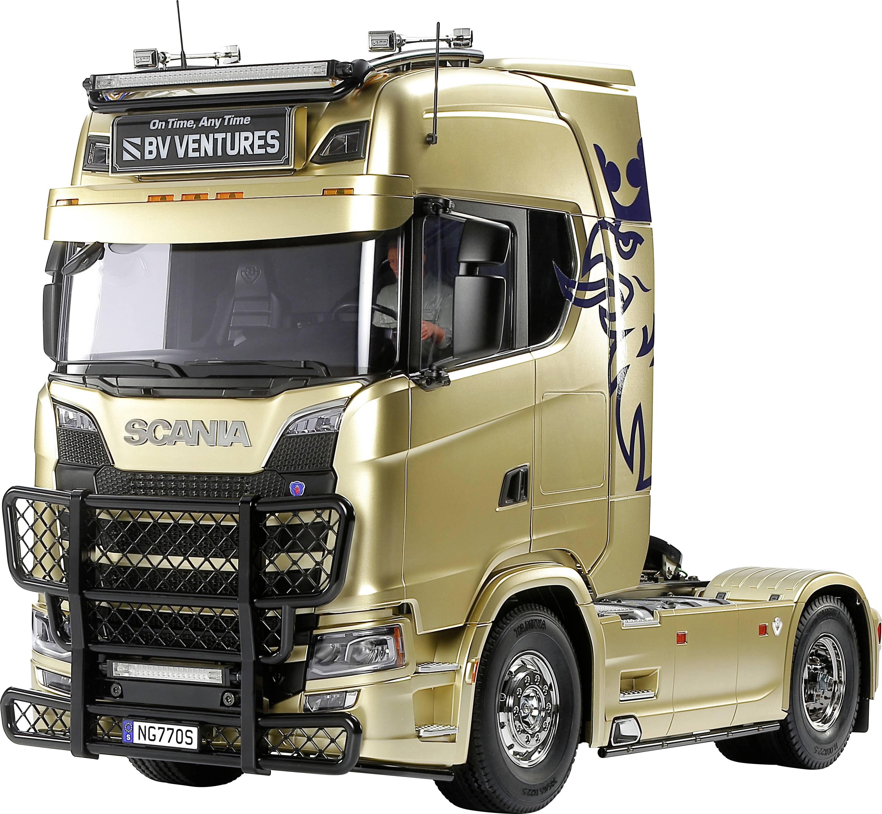 Golden Scania lorry with decorative side graphics, parked and visible in profile.