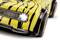 RC car in yellow and black tiger-stripe pattern with illuminated headlights, close-up of the front and wing.