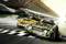 Two racing cars with black and yellow, as well as black and green stripes, cross the finish line on a racetrack.