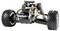 A remote-controlled car chassis with an exposed engine and suspension, highlighted wired components and chunky tyres.
