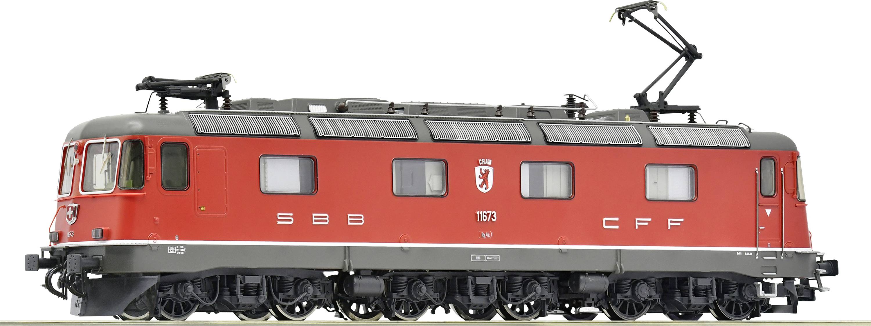 A red train with the inscription 'SBB CFF'. This is a model locomotive of the Swiss Federal Railways with overhead electric lines.