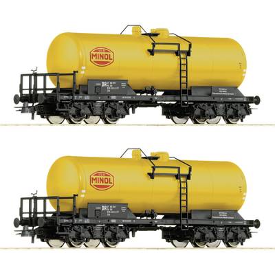 Two yellow tanker wagons with 'Minol' written on their sides, featuring black details, are standing on railway tracks.