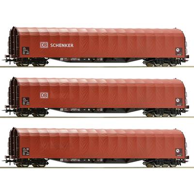 Three red freight wagons with the inscription 'DB Schenker' and 'DB' on their sides, set against a neutral background.