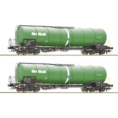 Two green tanker wagons with the inscription 'On Rail', standing side by side on railway tracks.