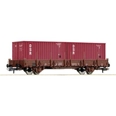 A brown goods wagon with red containers, labelled 'DSR', standing on a railway track.
