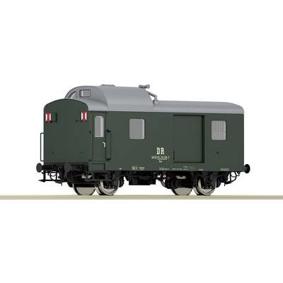 Green goods train with grey roof on railway tracks, bearing 'DR' inscription, used for postal transportation, with two axles and red signals.
