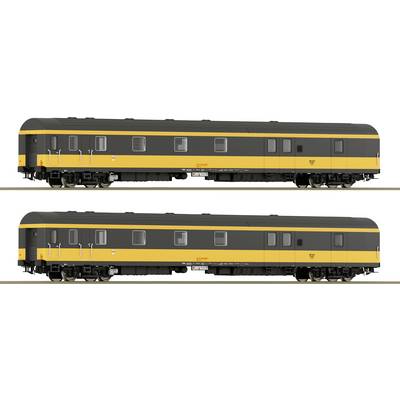 Two identical black and yellow railway carriages stand side by side on tracks, with windows and doors along their sides.