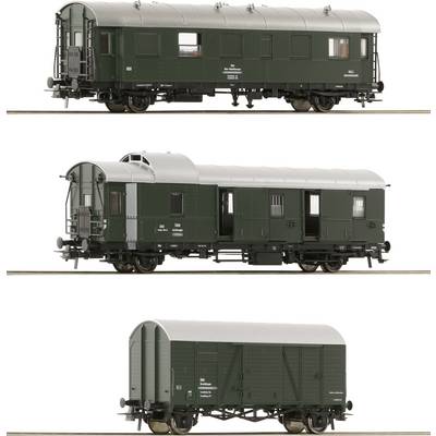 Three model railway carriages in different views: A green passenger carriage, a goods wagon with lattice windows, and a closed goods wagon.