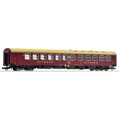 A red model train Mitropa carriage with a yellow roof and 'MITROPA' inscription. The carriage has numerous windows and is intricately designed.