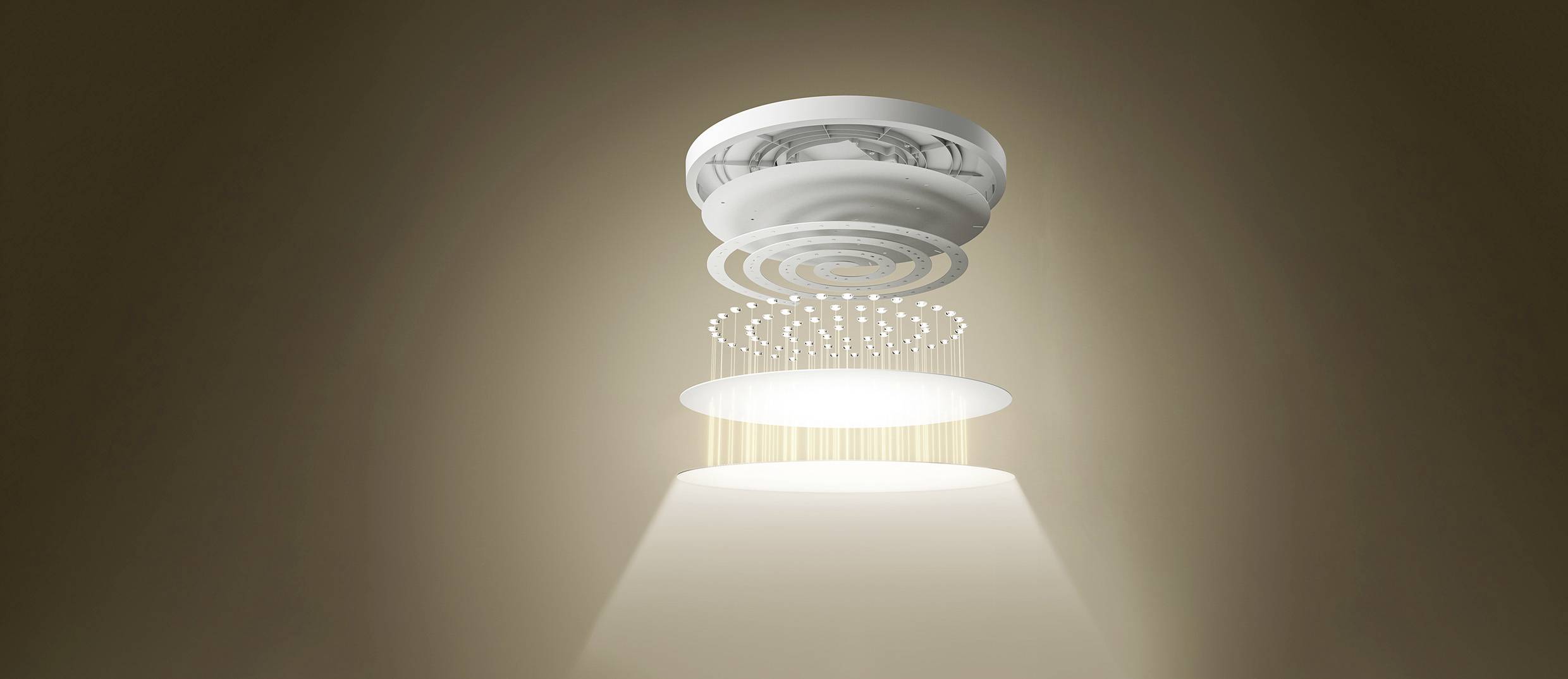 A smoke detector on the ceiling emits a light beam that illuminates the area below in a dimly lit room.