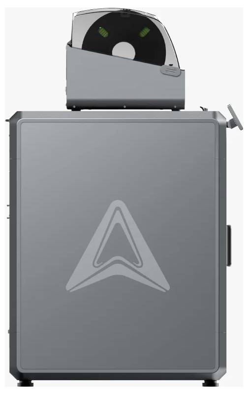 A 3D printer with a large metal enclosure and a filament reel on the top surface. A stylised logo is displayed on the front.