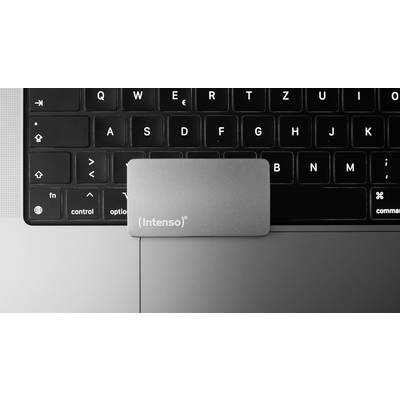 External 'Intenso' hard drive lying on a laptop keyboard.
