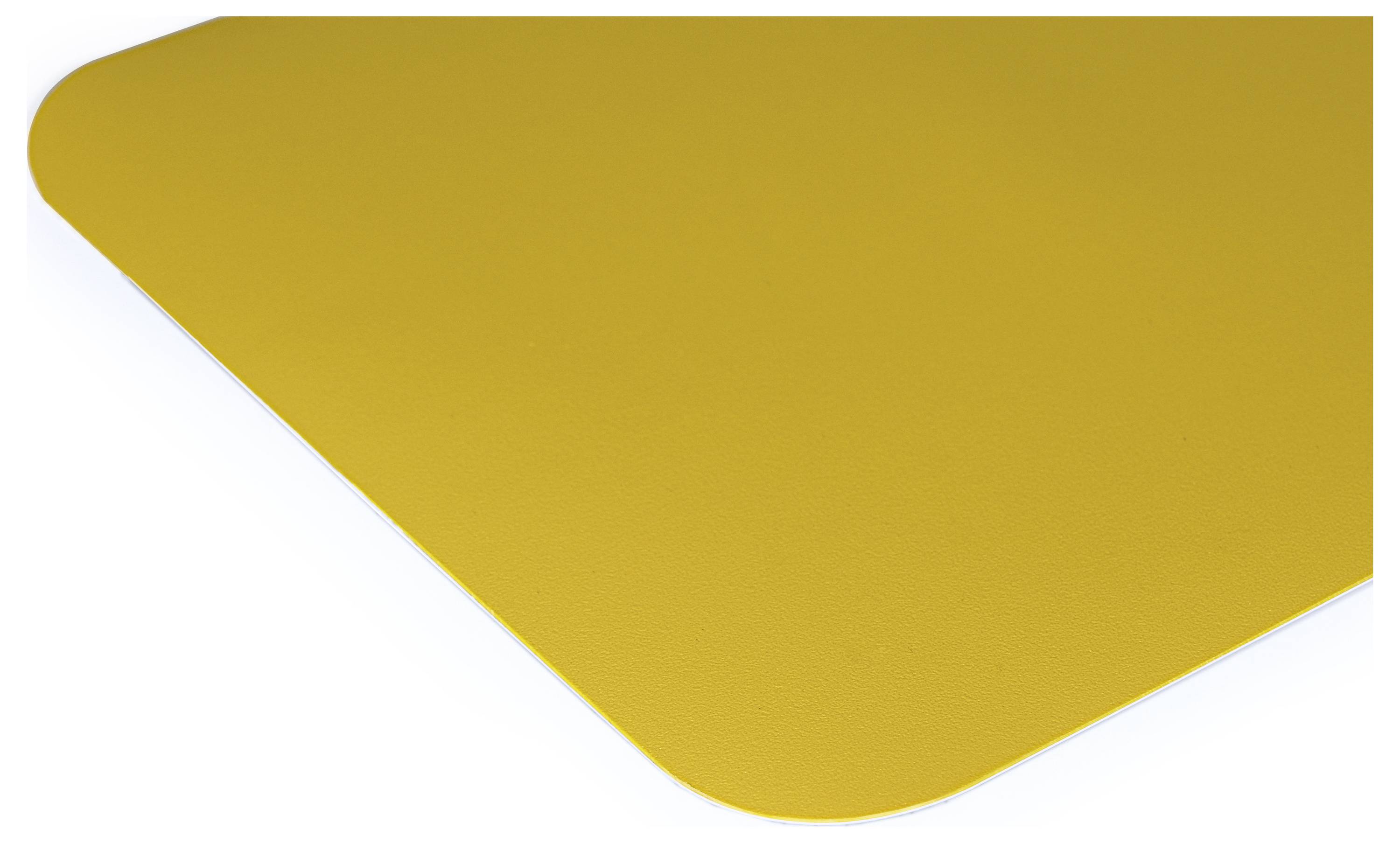 Corner of a yellow, textured surface, possibly a table or mat, in close-up, without further details.