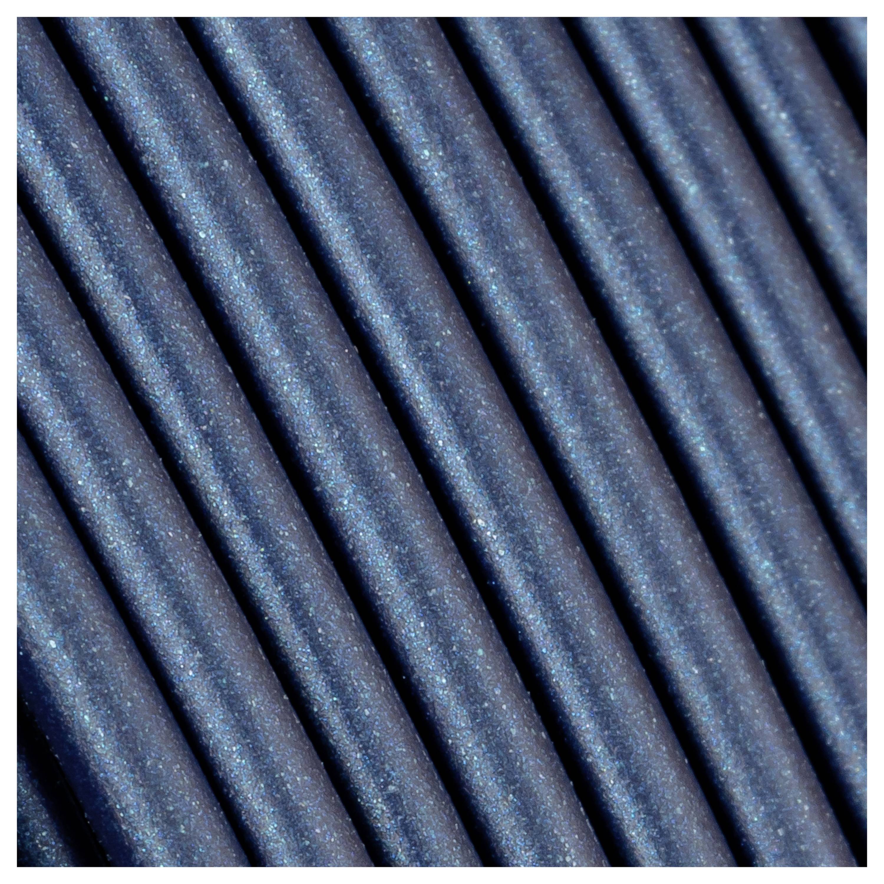 Detailed close-up of dark blue, parallel-running wires or cables that are richly textured and tightly bundled.