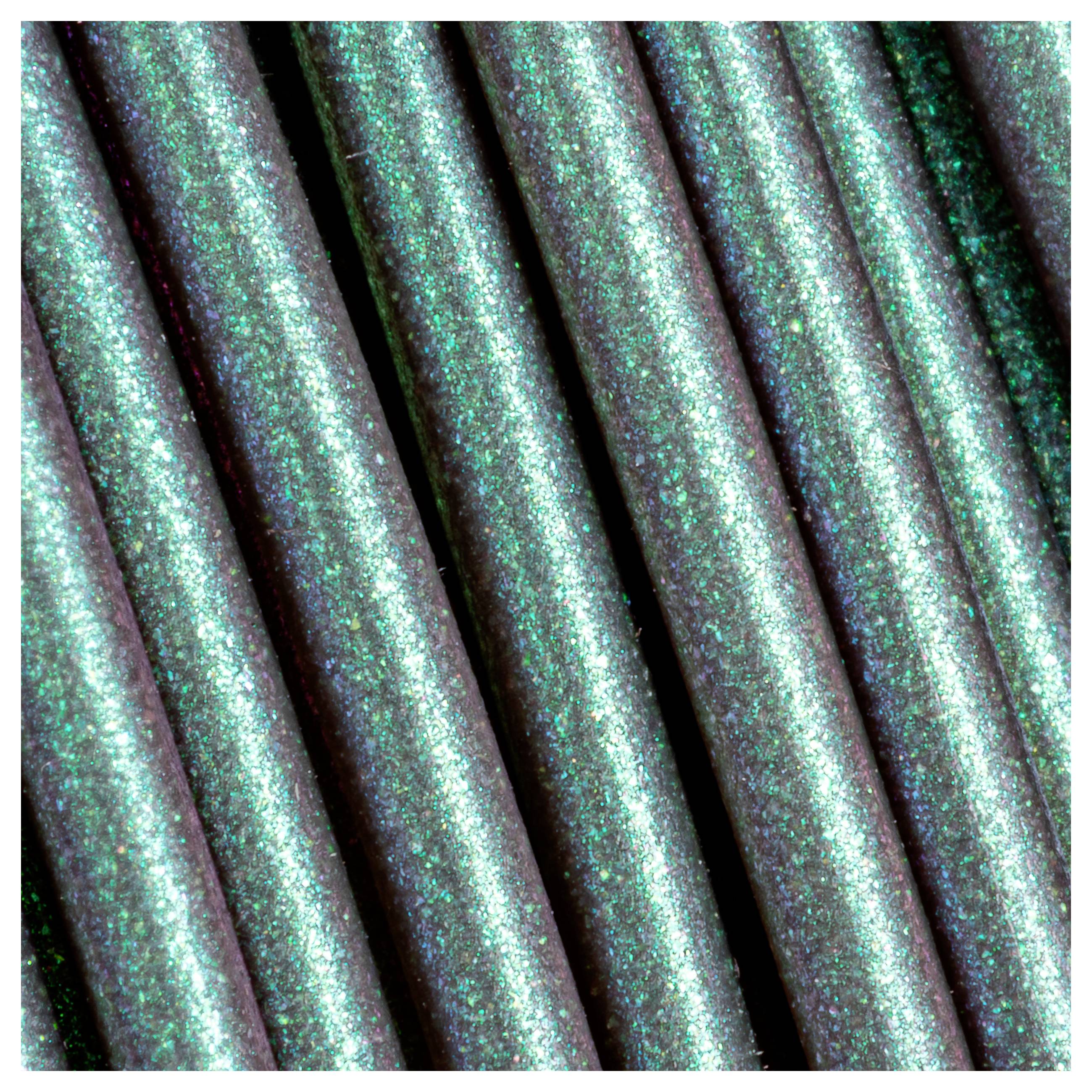 Several green glittering pens side by side in close-up. Glitter particles reflect the light, creating a luminous effect.