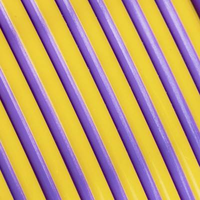 Yellow and purple plastic strips run parallel in a diagonal arrangement.